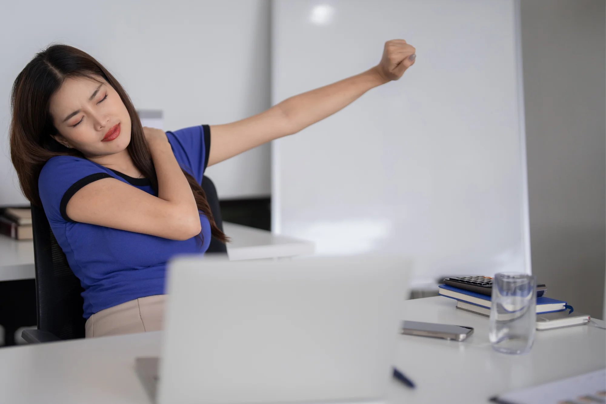 Woman stretching her shoulder