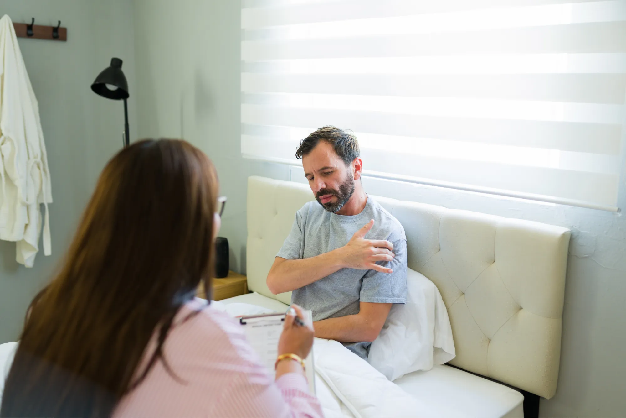 A patient explaining to his doctor what his shoulder subluxation feels like.