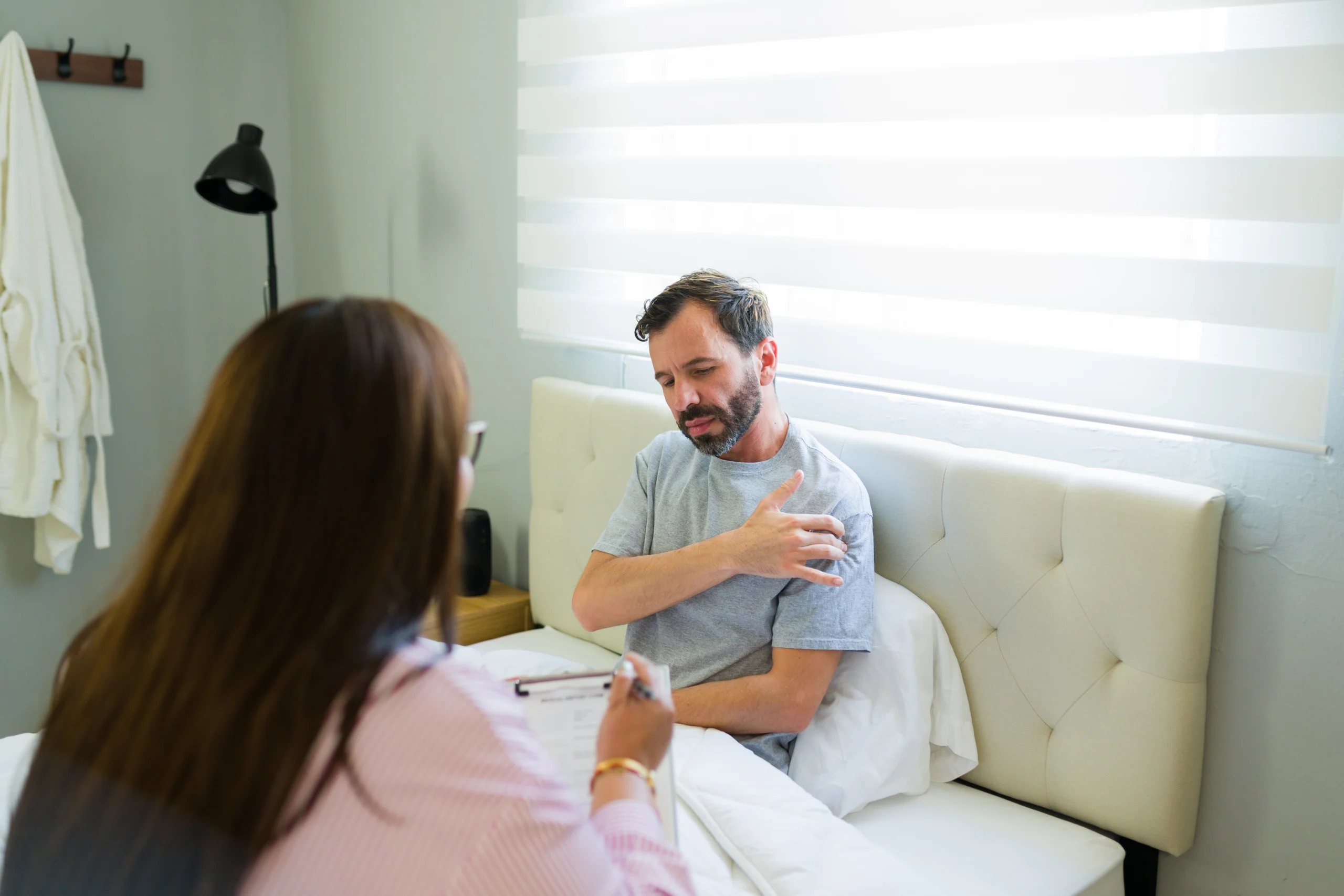A patient explaining to his doctor what his shoulder subluxation feels like.